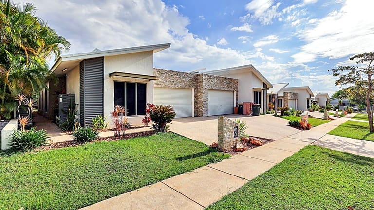 The street-front exterior of an EPNT supported accommodation home in Darwin, with a verandah and tropical garden